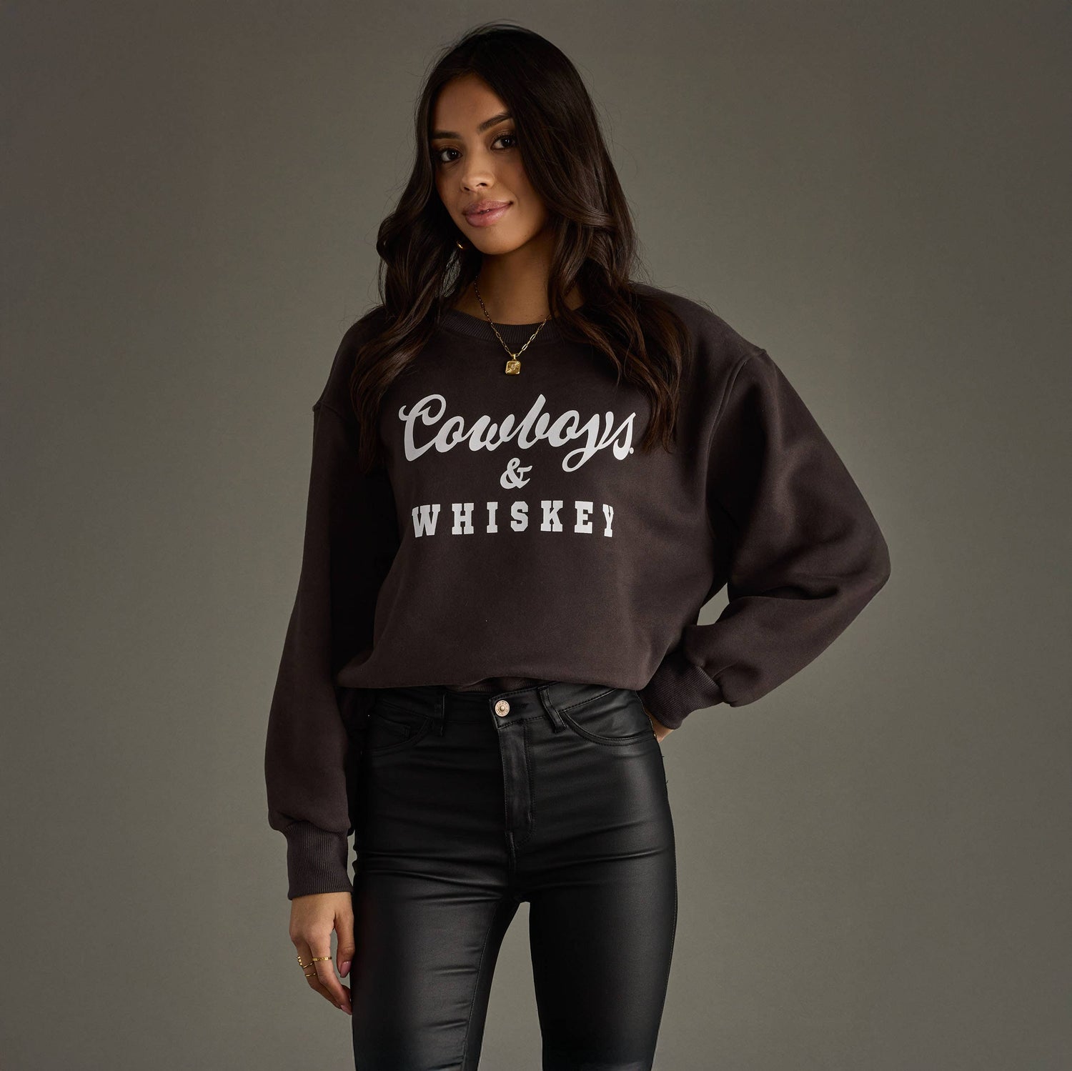 Woman wearing a dark brown sweatshirt with &