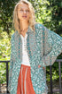 Woman wearing a floral kimono in an outdoor setting