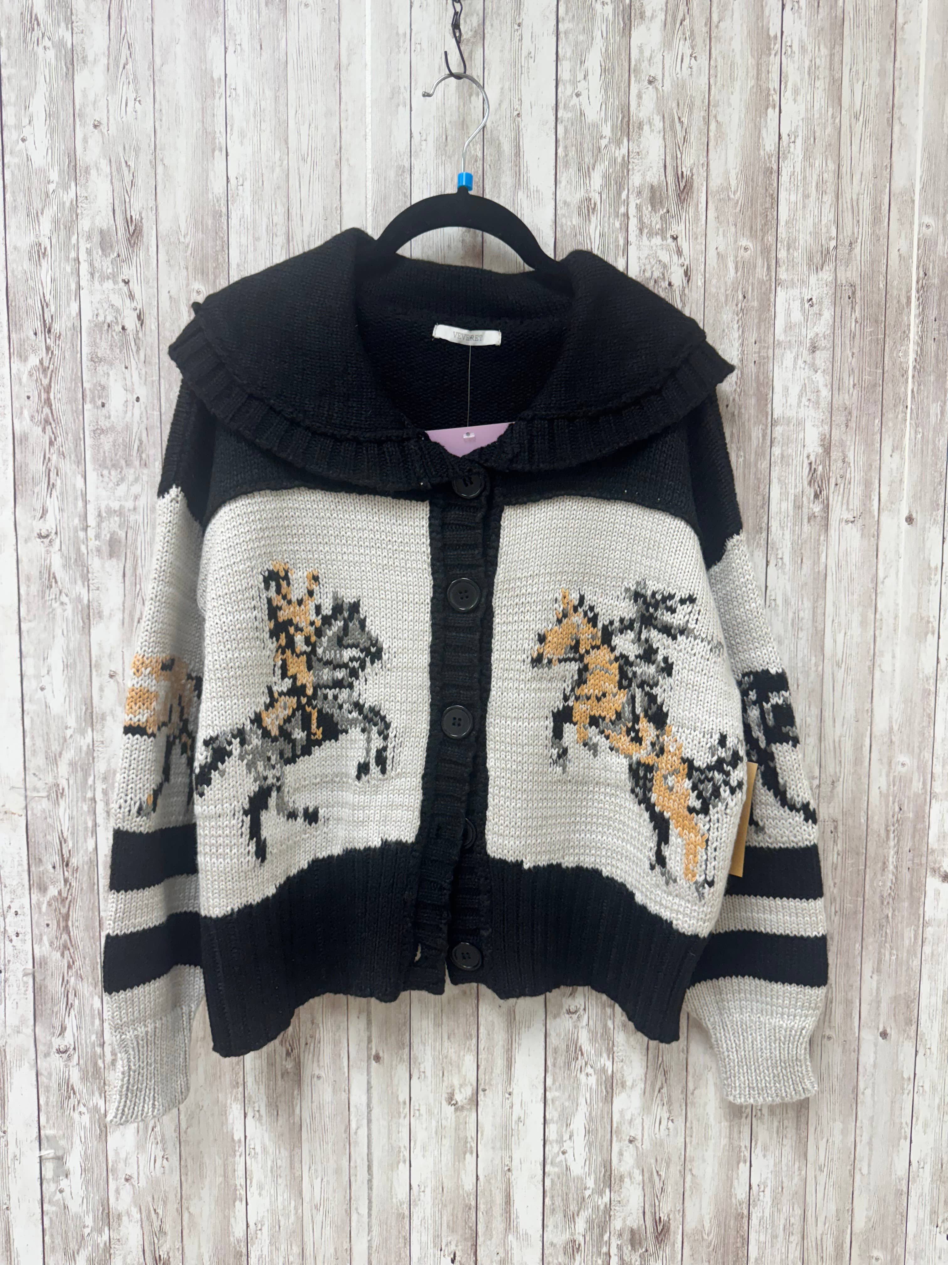 Knitted cardigan with horse patterns on a wooden background