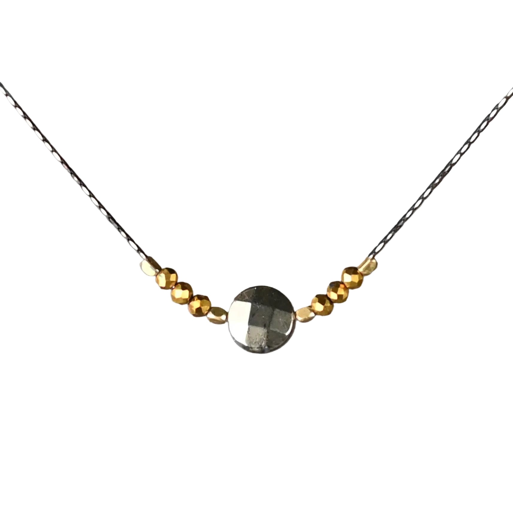 Necklace with gold and silver beads on a gray background