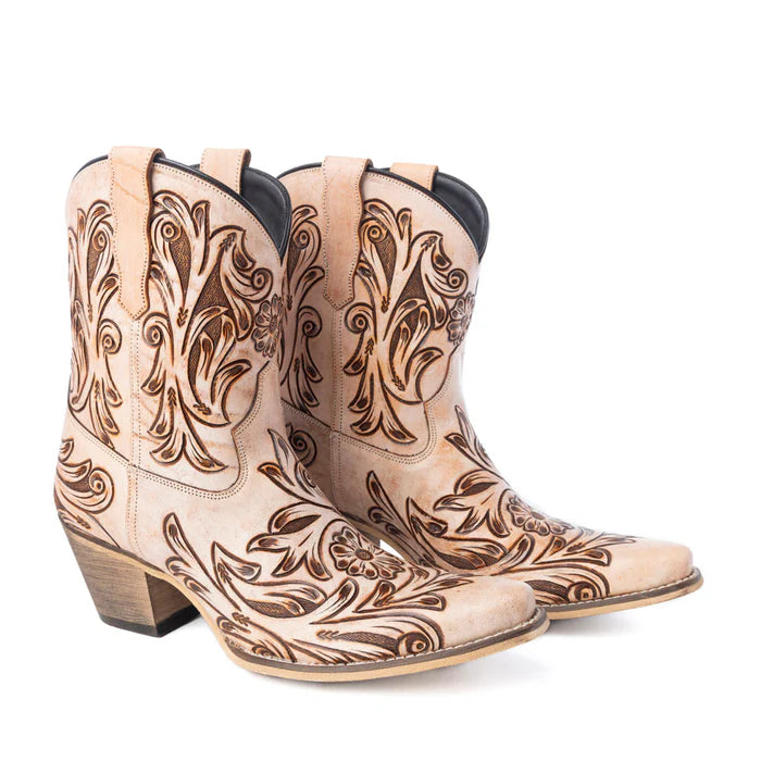 Pair of beige cowboy boots with intricate brown leather patterns on a white background