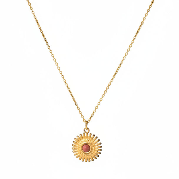 Gold necklace with a sun pendant on a &
