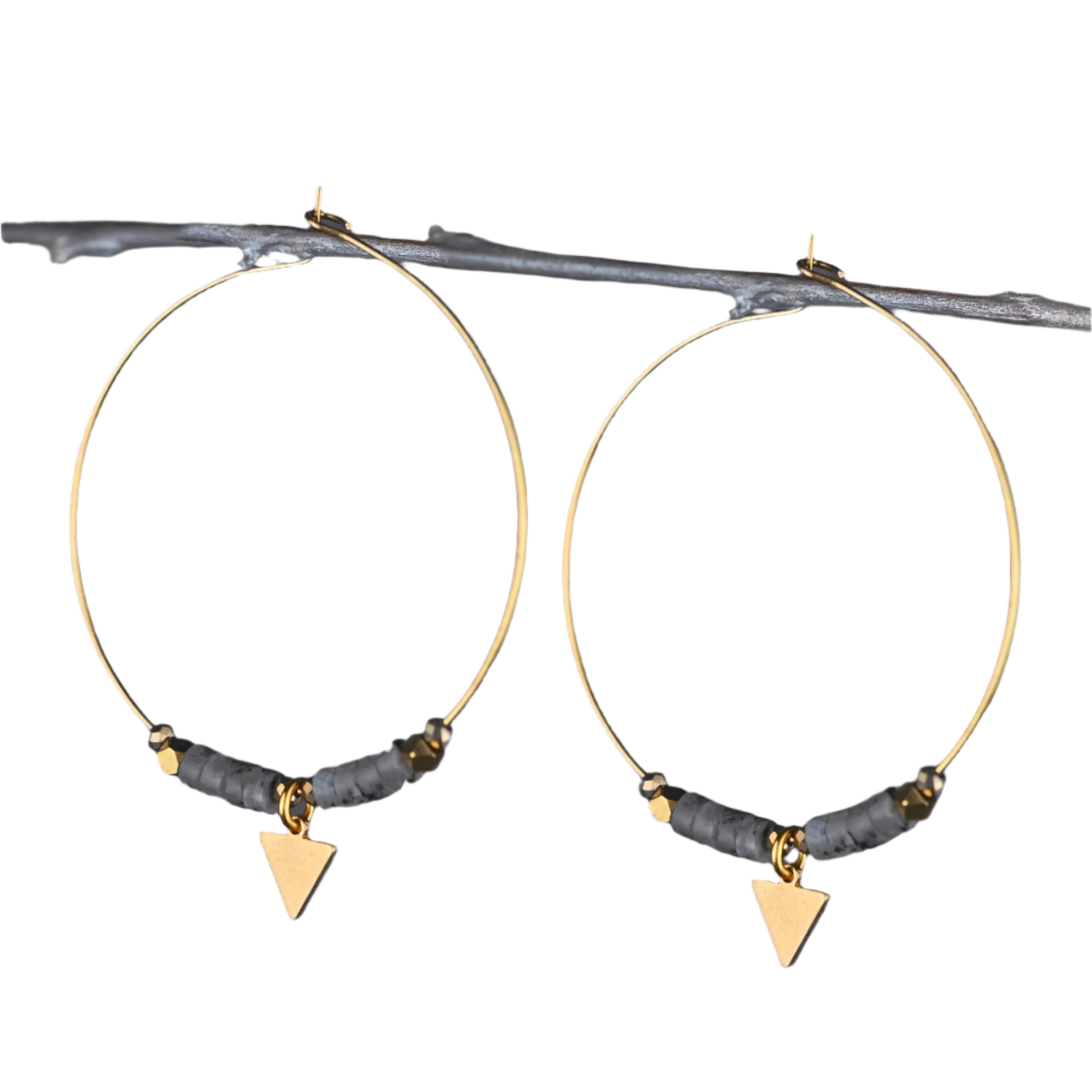 Handmade Arrowhead Hoops featuring semi-precious beads, gold crystals, and a small brass arrow charm on brass hoops, measuring approximately 2.25 inches.