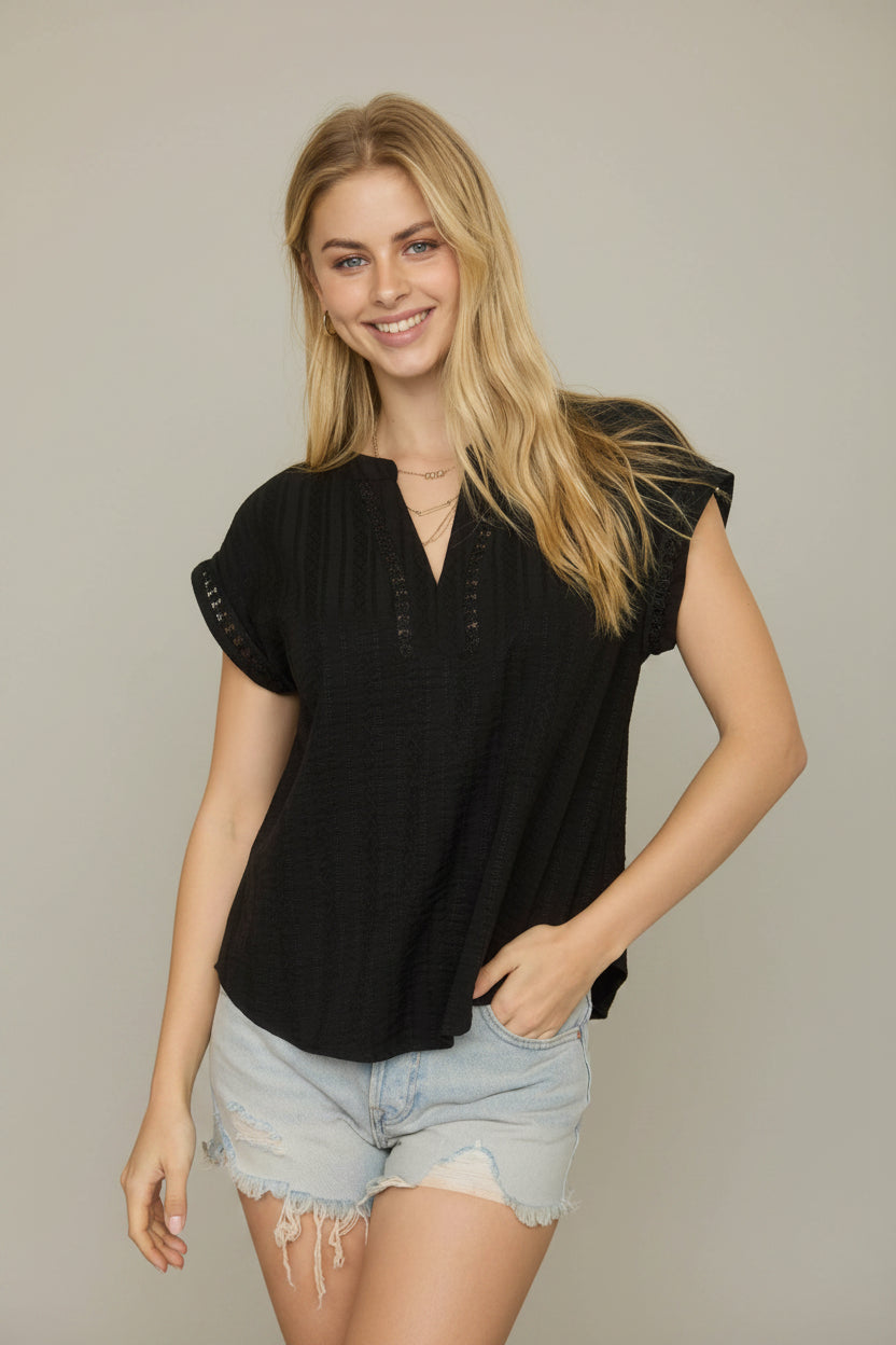 Black textured blouse with split neckline, short sleeves, and lace detail accents