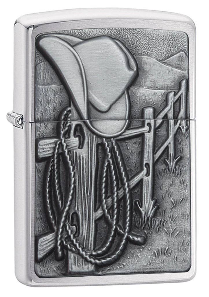 Zippo lighter with cowboy design featuring a hat, boots, and lasso.