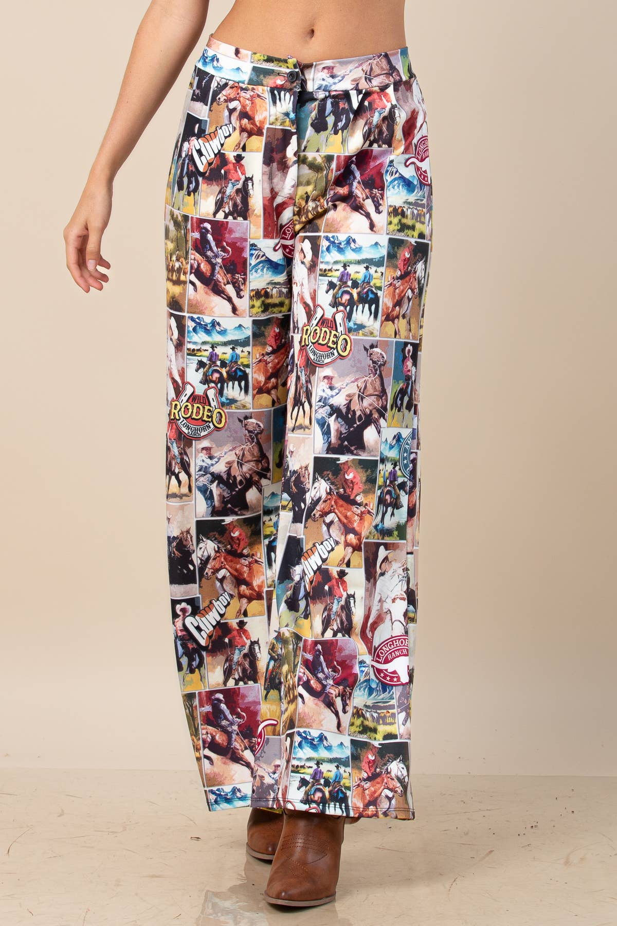 Western rodeo graphic print wide-leg pants with a front button, zipper closure, and elastic back waistband.