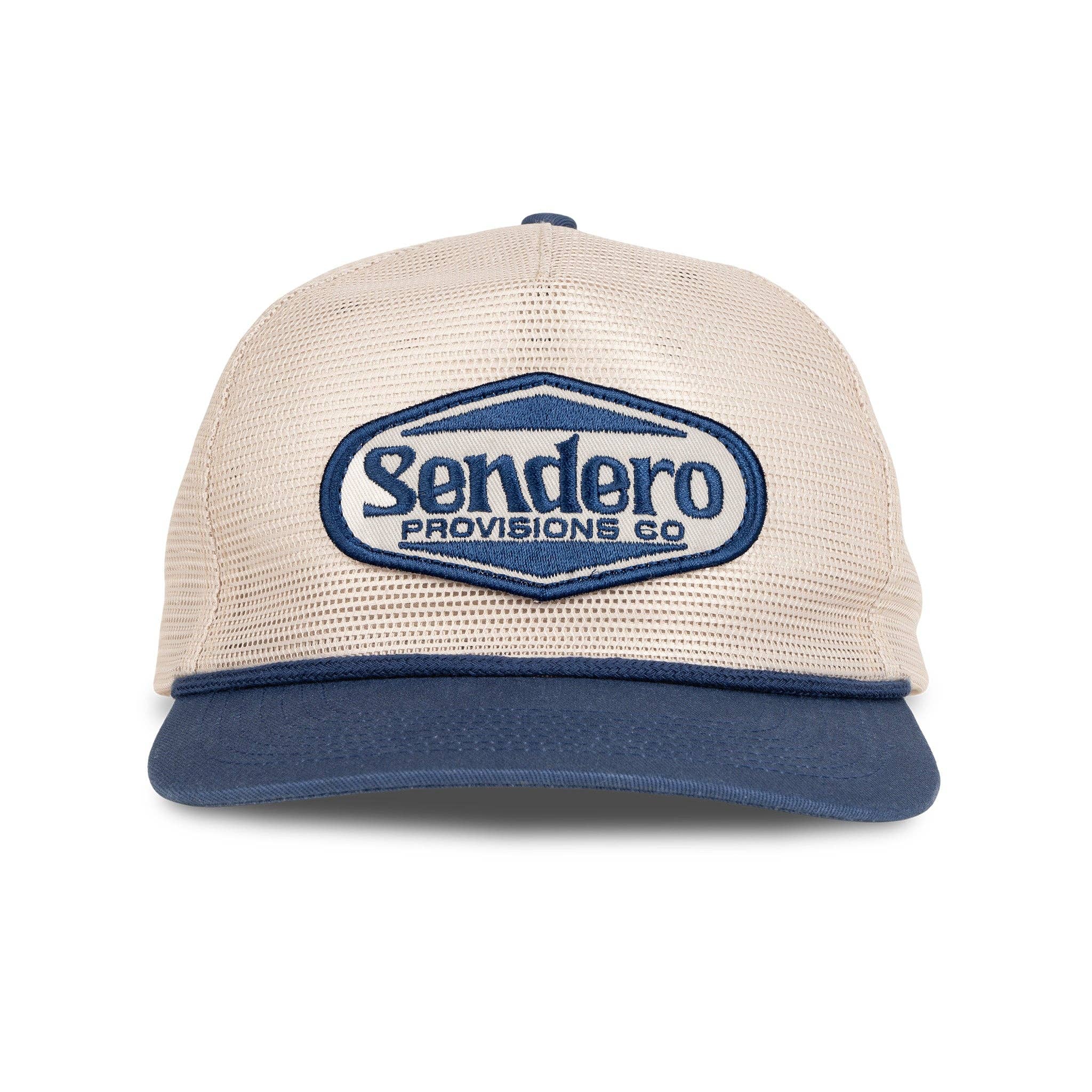 Beige and navy mesh trucker hat featuring an embroidered Sendero Provisions Co. logo patch on the front. Classic structured design with a breathable mesh back and adjustable fit.