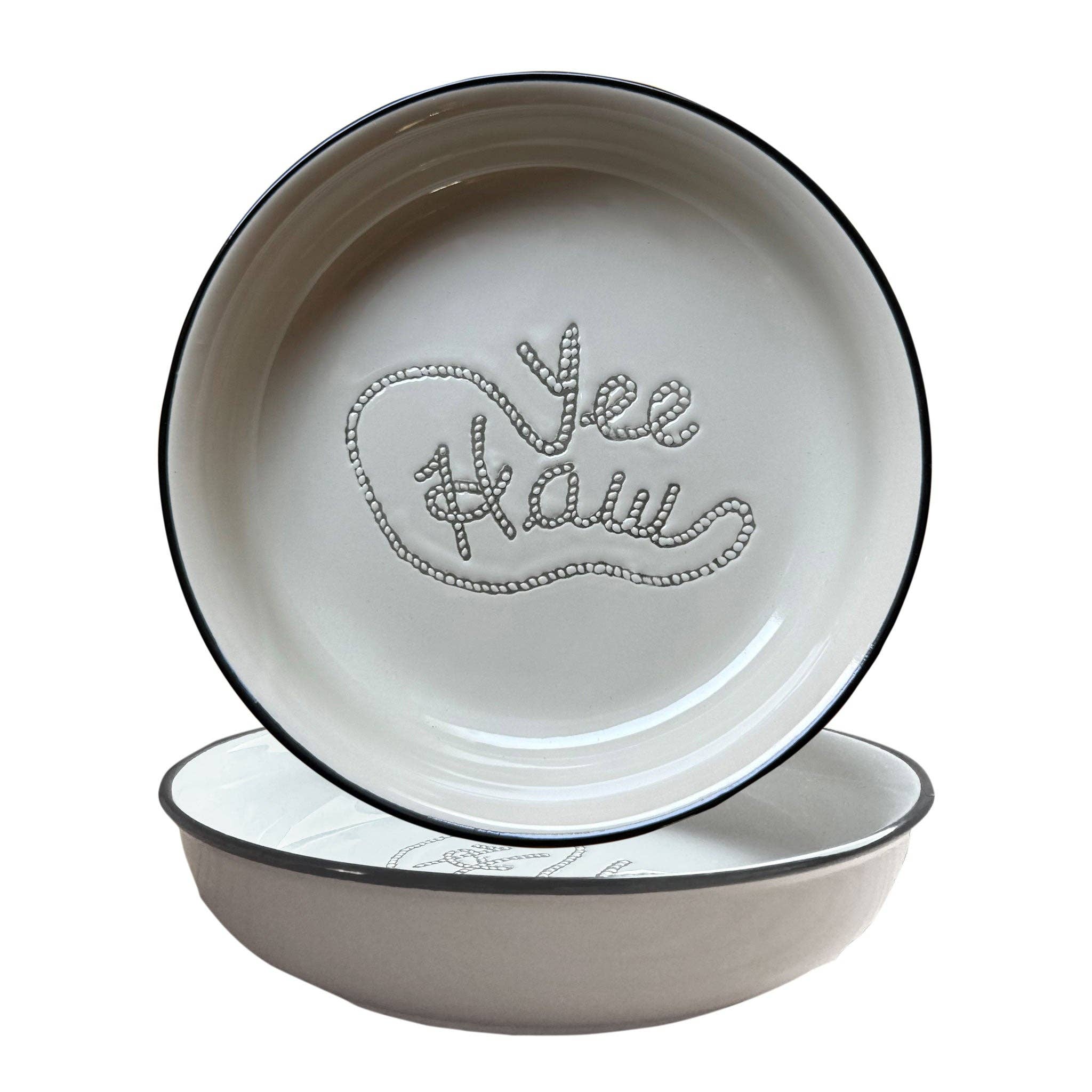 Ceramic pet bowl set with embossed yee haw rope design, shallow dog bowls with black rim on blue placemat, western style feeding set