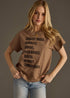 Woman wearing a brown t-shirt with text on a gray background