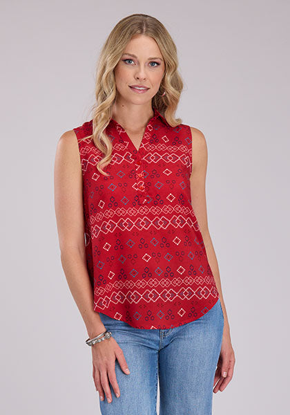 A woman wearing a red sleeveless shirt with a geometric pattern, paired with blue jeans.