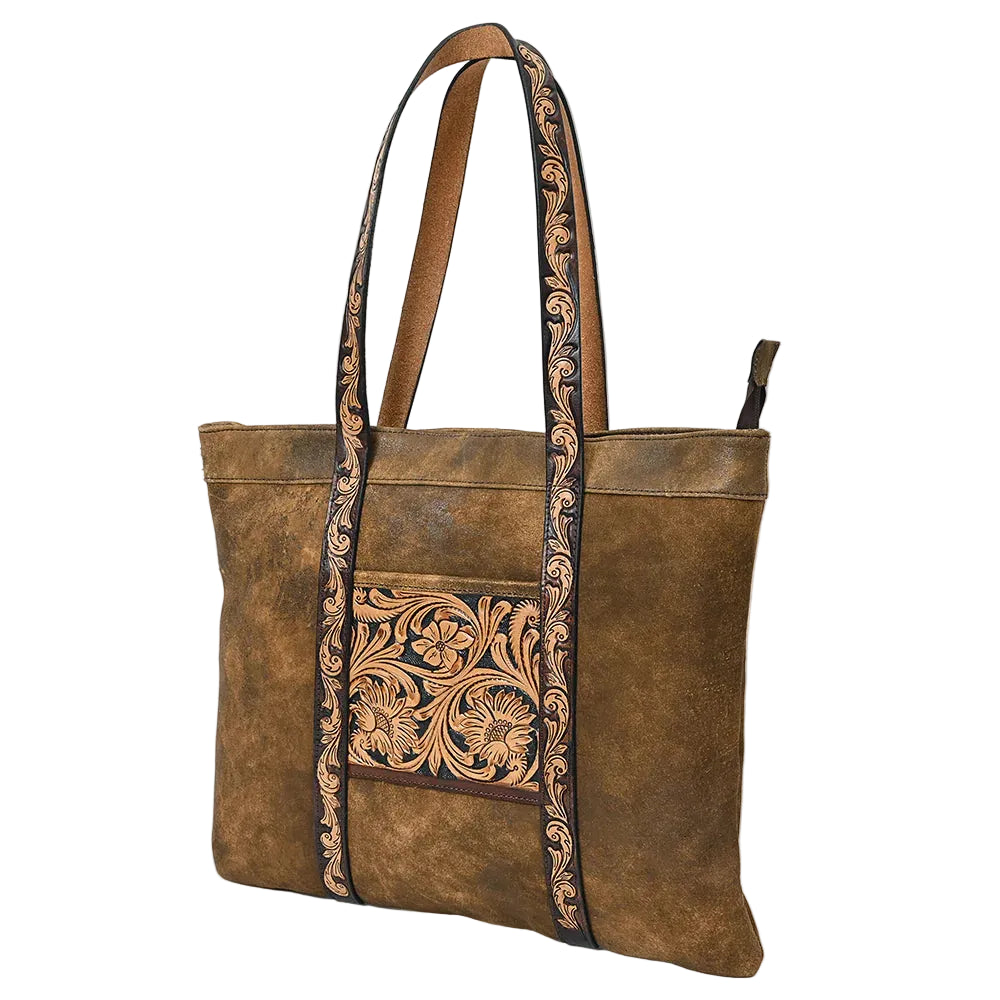 Brown leather tote bag with intricate floral patterns on a white background