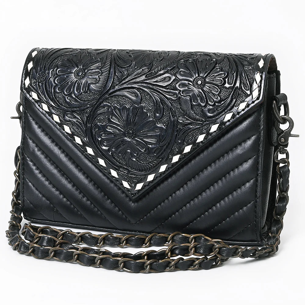 Black leather handbag with floral tooling and chain strap on a white background