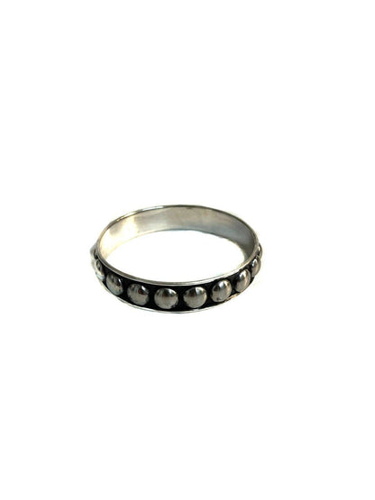Silver ring with embedded stones on a white background