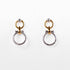 Pair of earrings with gold and silver rings on a white background