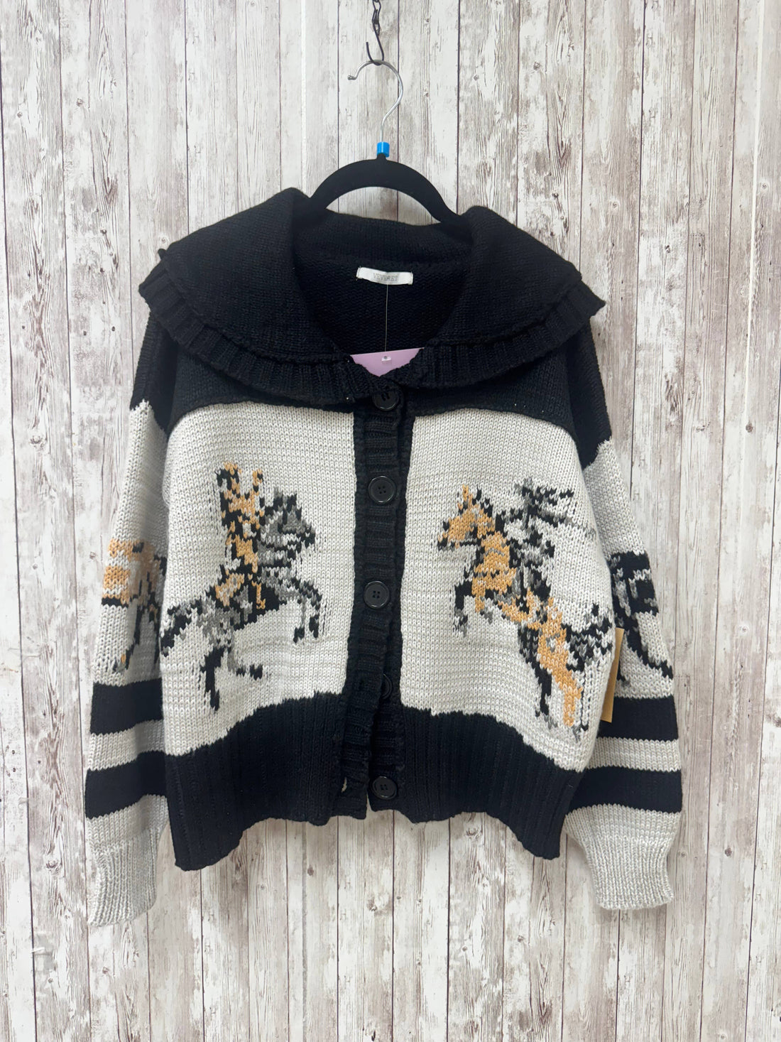 Knitted cardigan with horse patterns on a wooden background