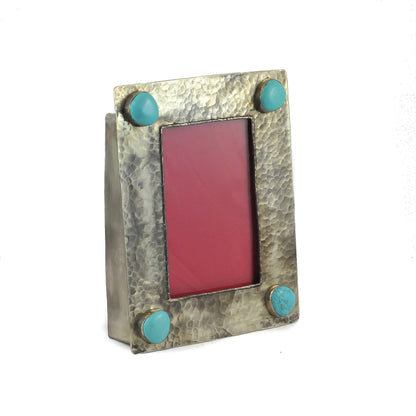 Metallic photo frame with turquoise accents on a white background