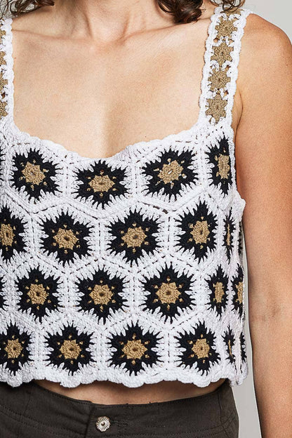 Model wearing the High Desert Crochet Tank, a handcrafted crochet crop top featuring a square neckline, wide floral-weave straps, scalloped edges, and a black, ivory, and camel granny square pattern, paired with an embroidered brown skirt.