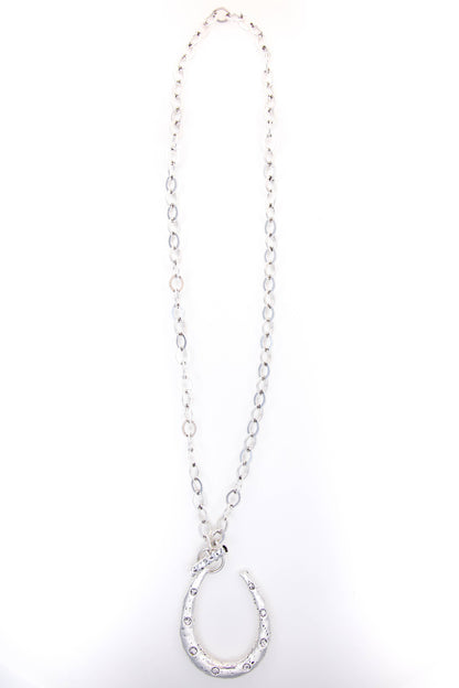 Silver necklace with a horseshoe pendant on a white background