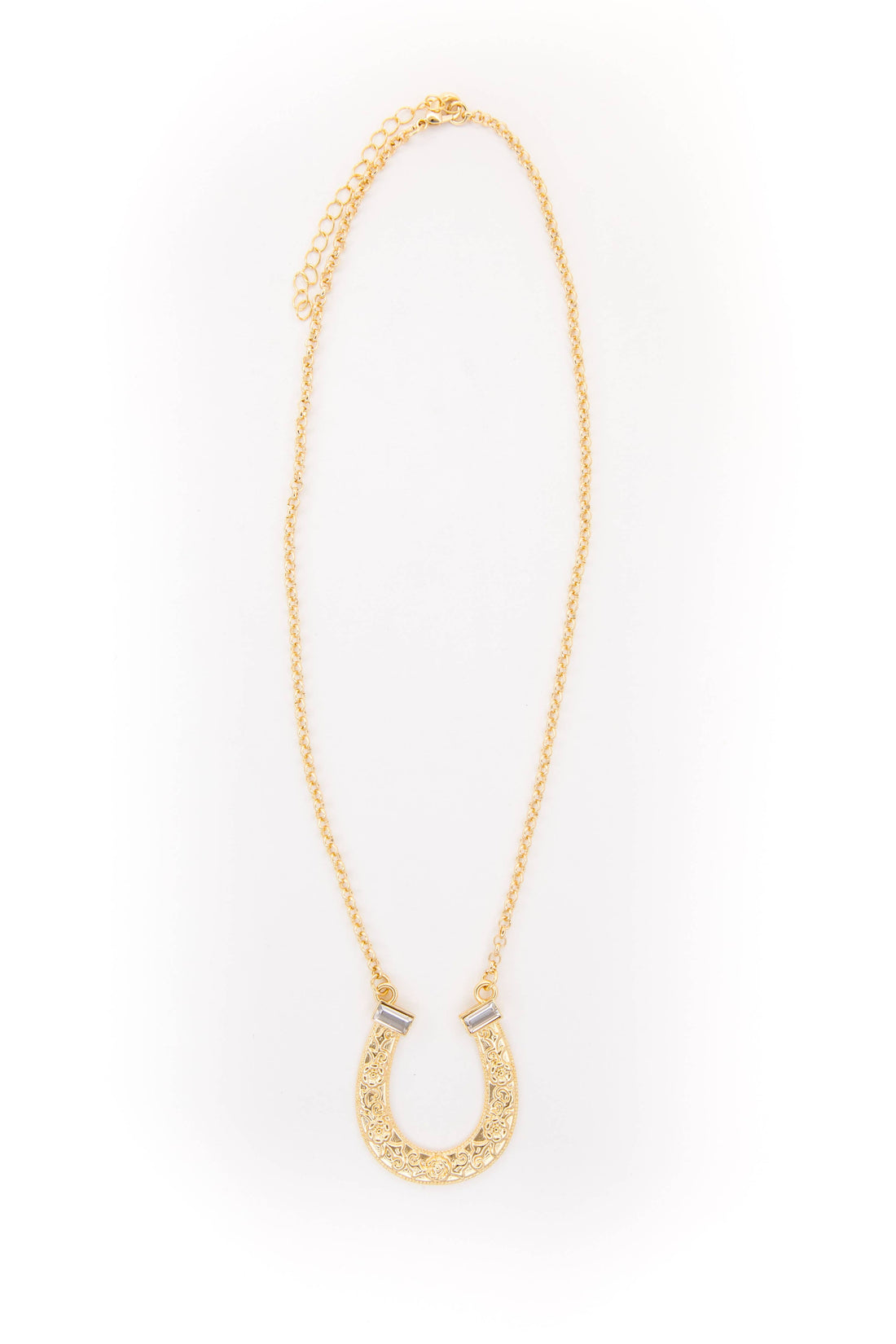 Gold necklace with a horseshoe pendant on a white background