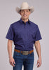 Man wearing a blue patterned shirt, jeans, and a cowboy hat on a gray background