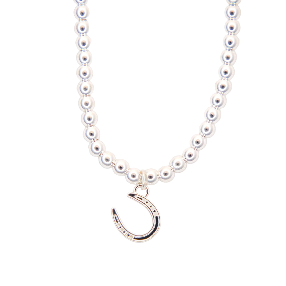 silver necklace with a silver horseshoe pendant on a white background