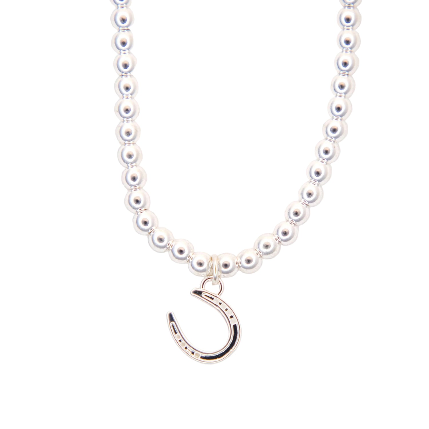 silver necklace with a silver horseshoe pendant on a white background
