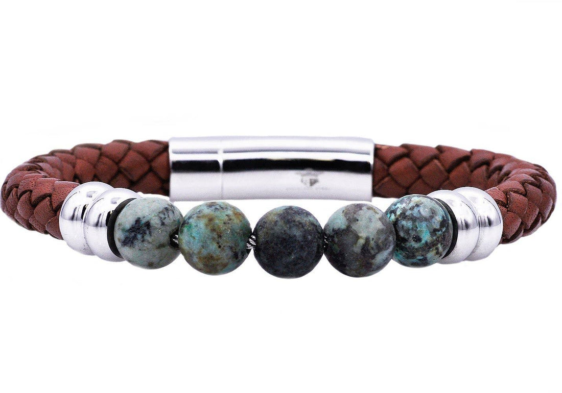 Bracelet with brown leather strap, turquoise beads, and silver clasp on a white background