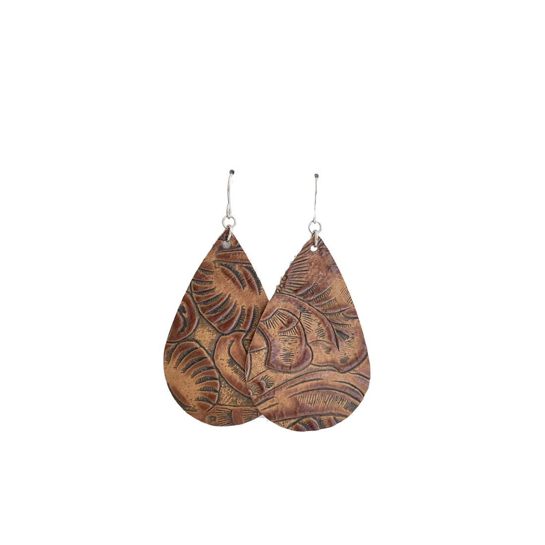 Pair of brown leather teardrop earrings with embossed designs on a white background