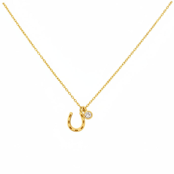 Gold necklace with a unique pendant on a black background