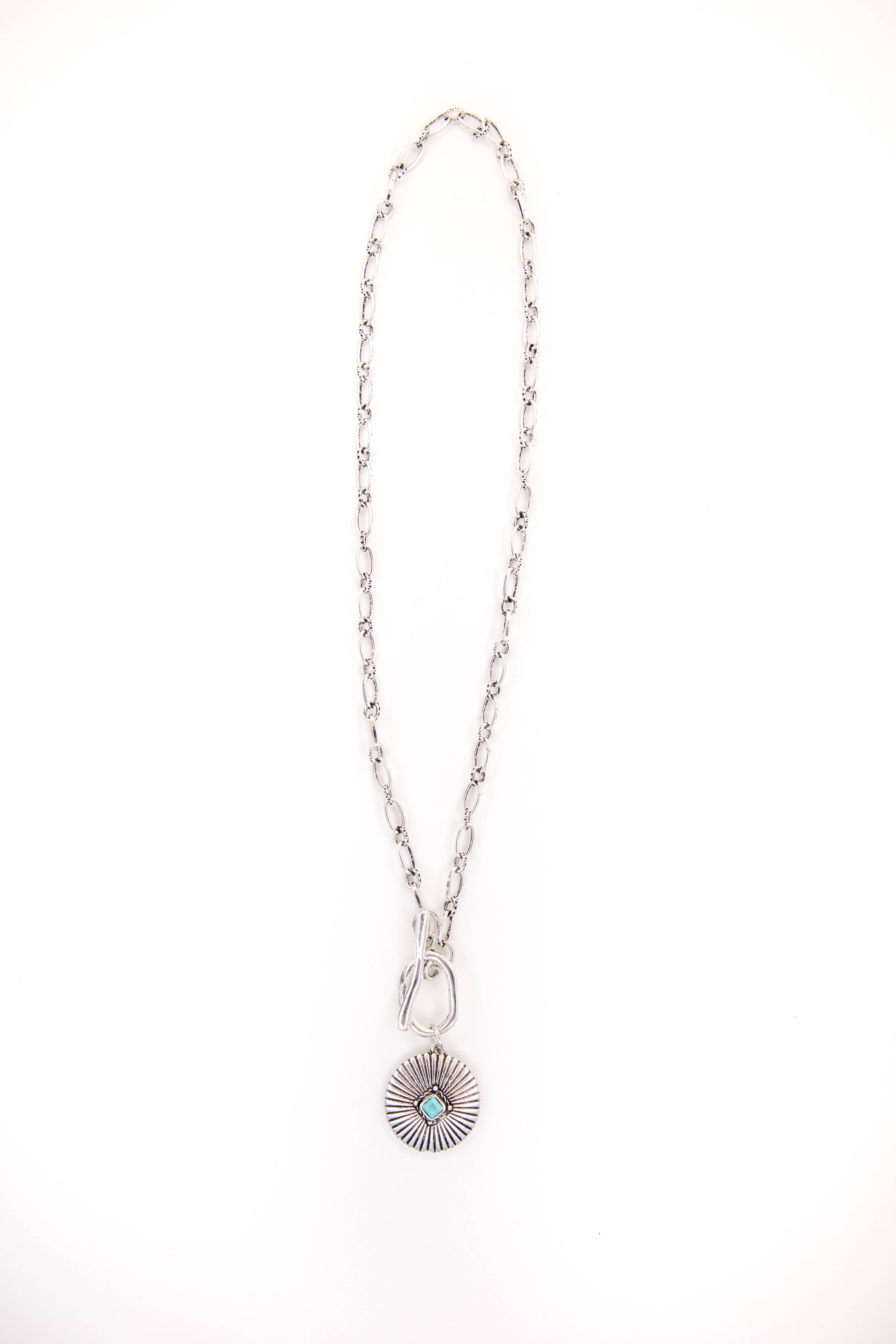 Silver necklace with a pendant on a white background