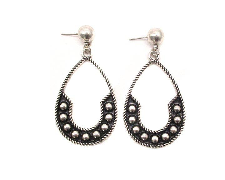 Pair of silver hoop earrings with bead detailing on a white background