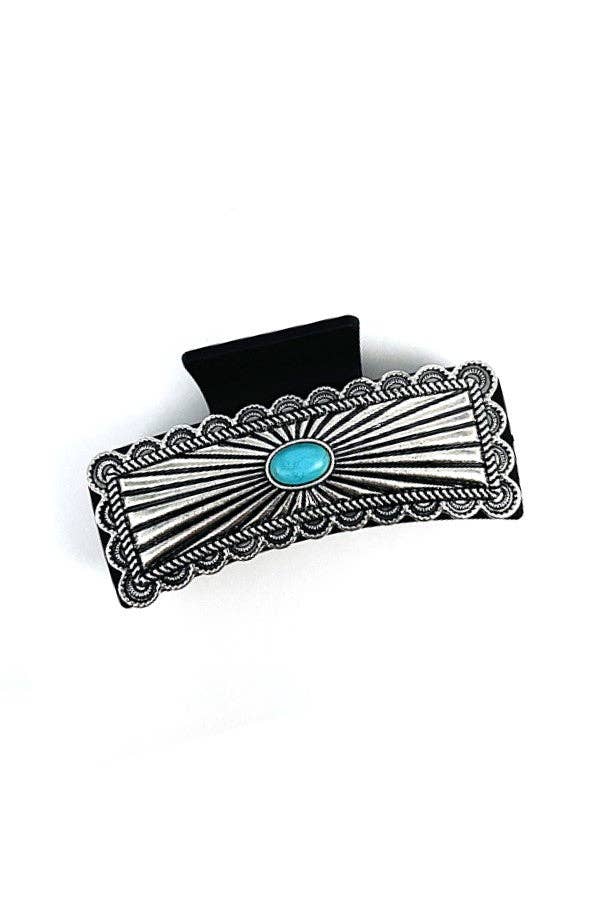 Silver belt buckle with turquoise stone on a white background