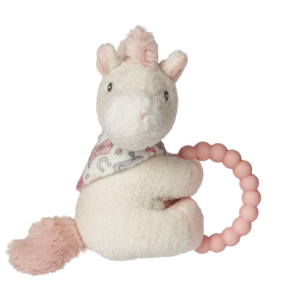 Plush unicorn toy with a pink teething ring on a white background