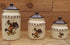 Three-piece Western canister set featuring a bronco buster illustration, dark brown rope and brands, and a beige glaze. Sizes include small, medium, and large, all with dark brown lids.