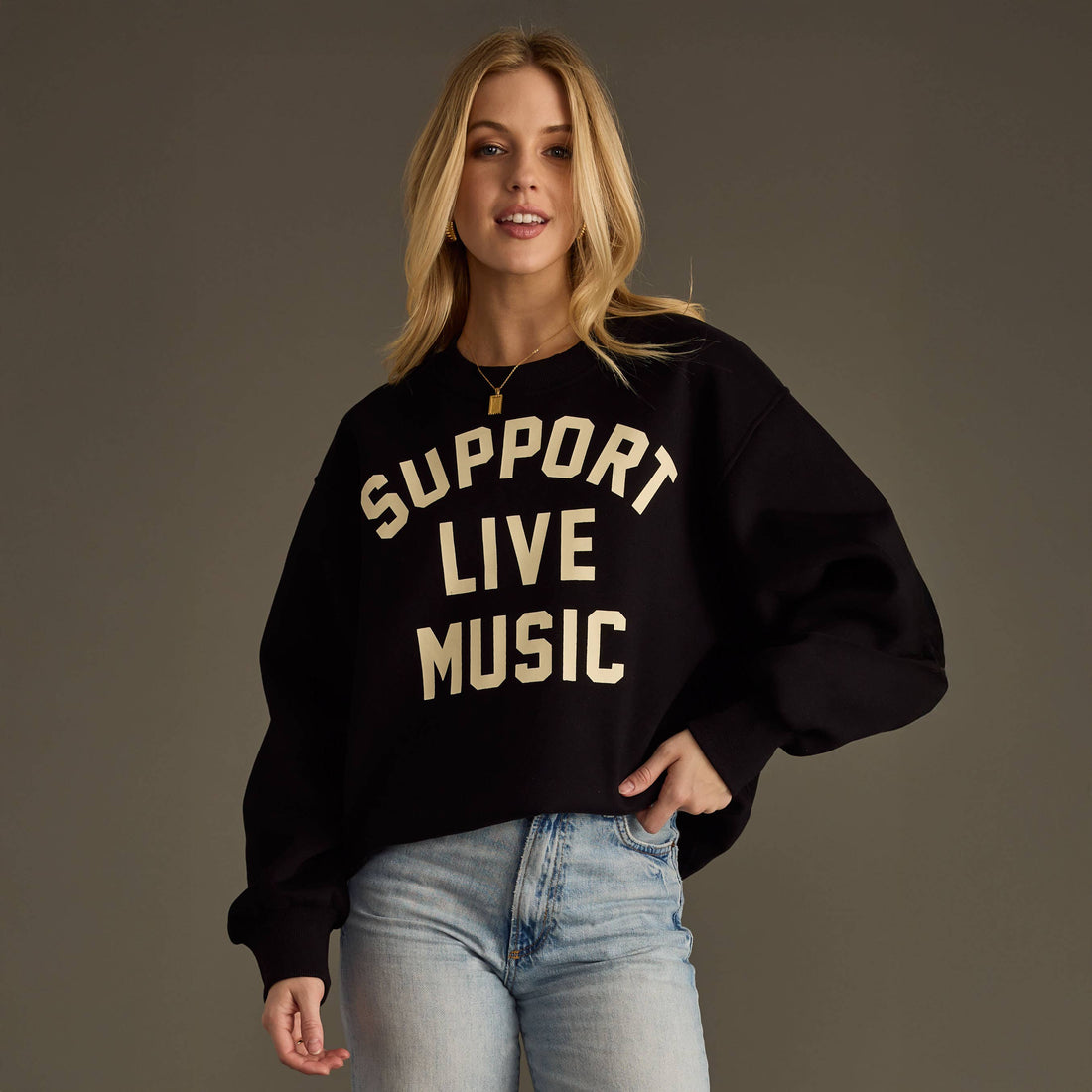 Woman wearing a black sweatshirt with &