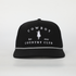 Black Cowboy Country Club trucker hat with white embroidered logo and rope detail