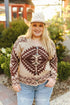 Woman wearing a patterned sweater and cowboy hat with a blurred background