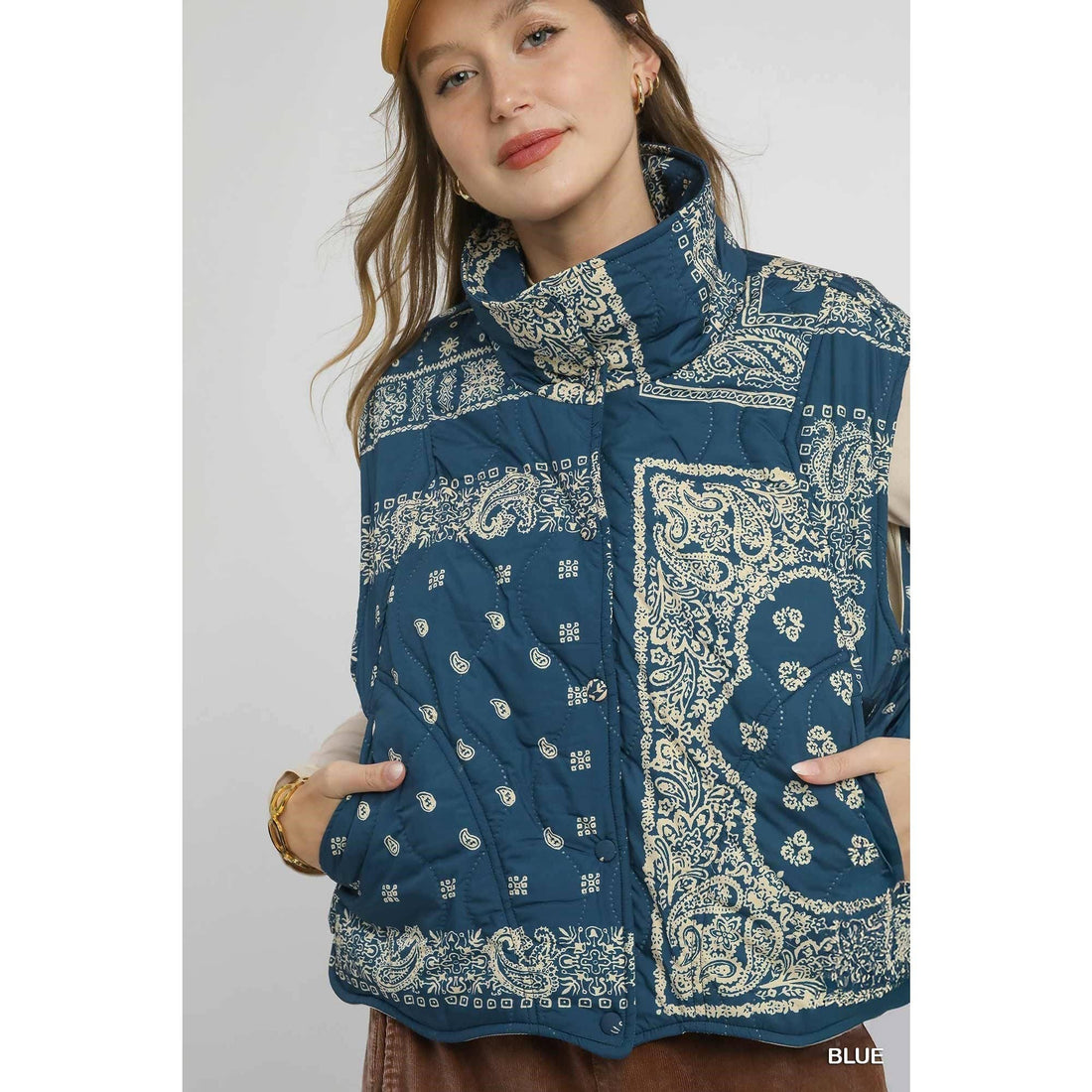 Woman wearing a blue patterned jacket on a white background