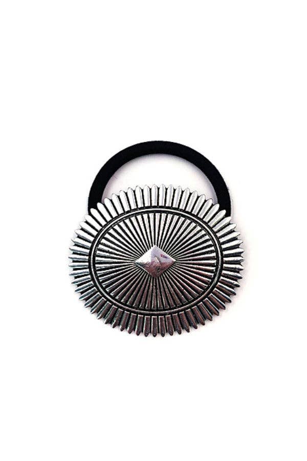 Decorative brooch with sunburst design on a white background