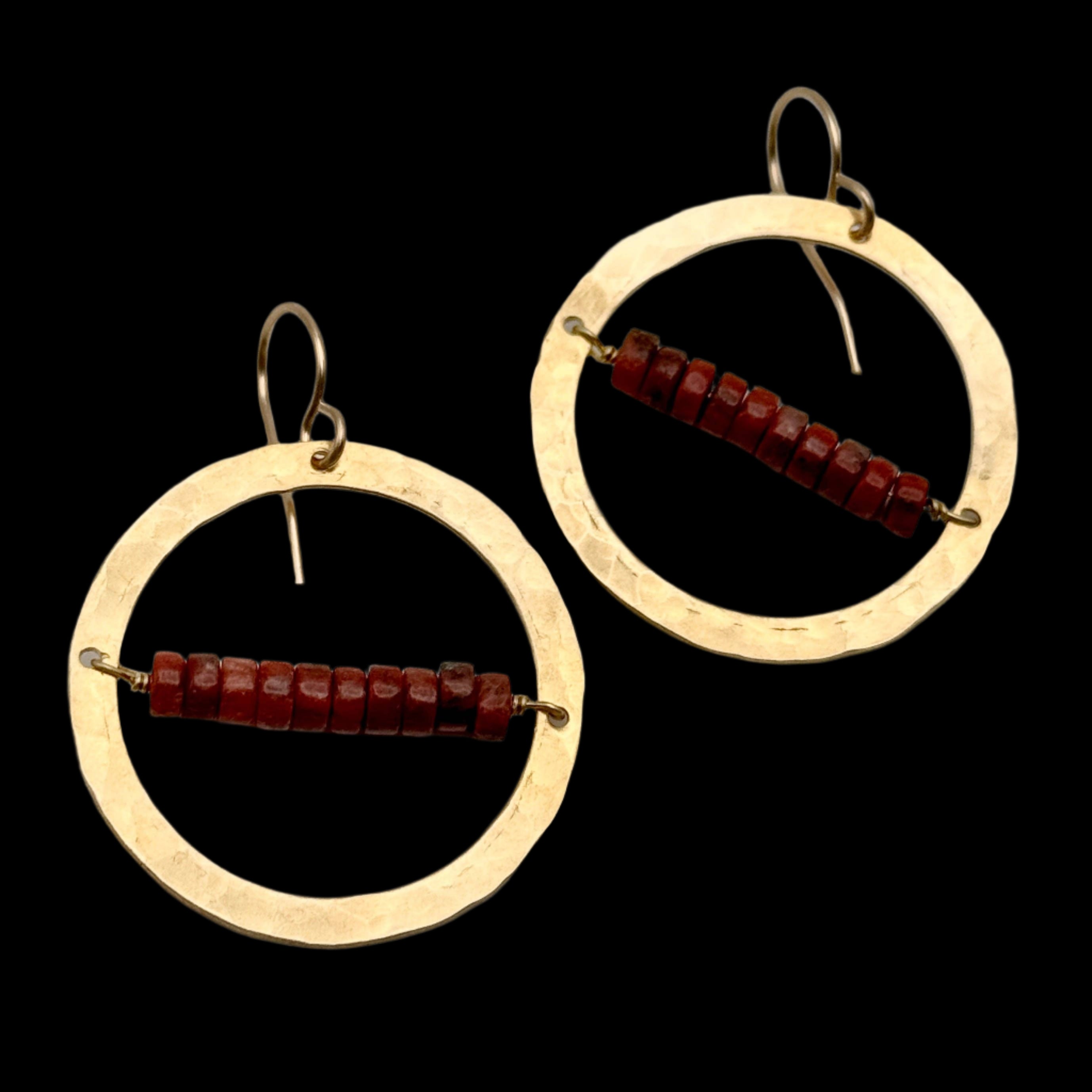 Handmade Desert Ember Hoops featuring red jasper stones wrapped inside a gold textured hoop, hanging from hypoallergenic 14k gold-filled ear wires.