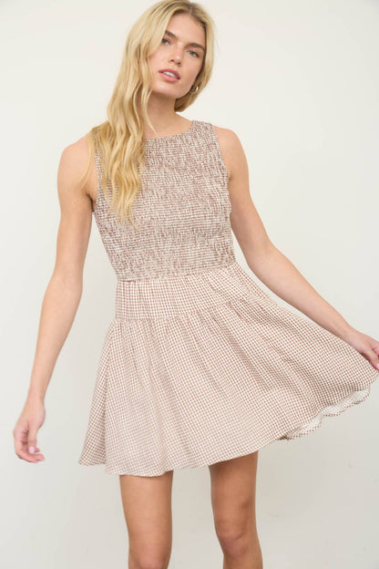 Smocked gingham mini dress with sleeveless design and A-line silhouette