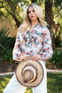 Western running horse print blouse with a V-neckline, self-tie bow, long sleeves, and elastic cuffs. Lightweight fabric with a little stretch.