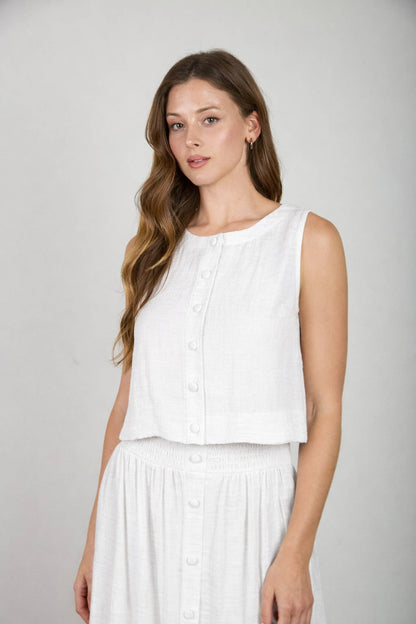 White sleeveless textured woven tank top with round neckline and button front detail