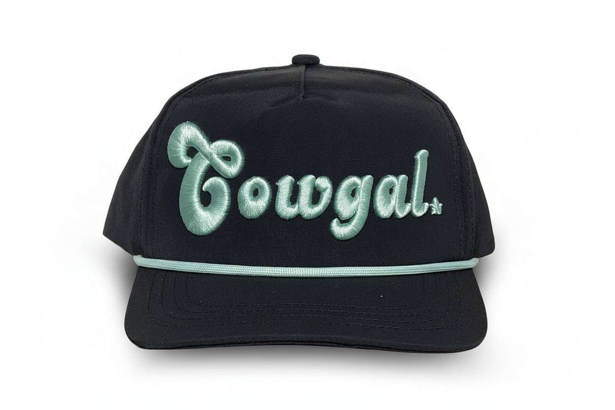 Infant cowgal cap in black with mint embroidered “Cowgal” lettering and rope detail across the brim, western-style baby hat