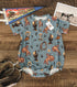 Baby western bamboo viscose bubble romper in vintage indigo blue with bronc, cactus, boot, and rope print, oversized fit with wood buttons and snap closure