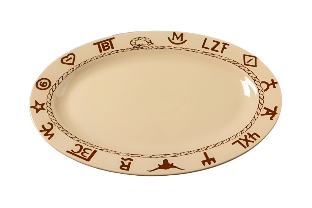18-inch oval ceramic platter featuring a beige glaze with dark brown western ranch brands and rope detailing around the rim. Microwave and dishwasher safe.