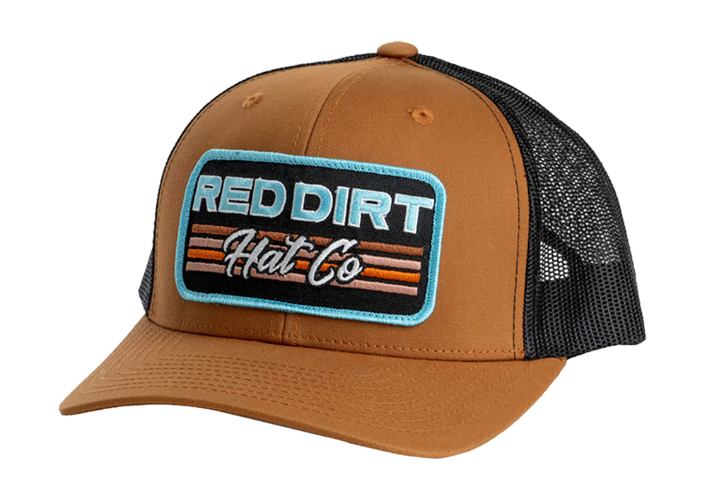 Red Dirt Hat Co. Between the Line Hat featuring a brown front panel, black mesh back, embroidered logo patch with retro stripes, and snapback closure.