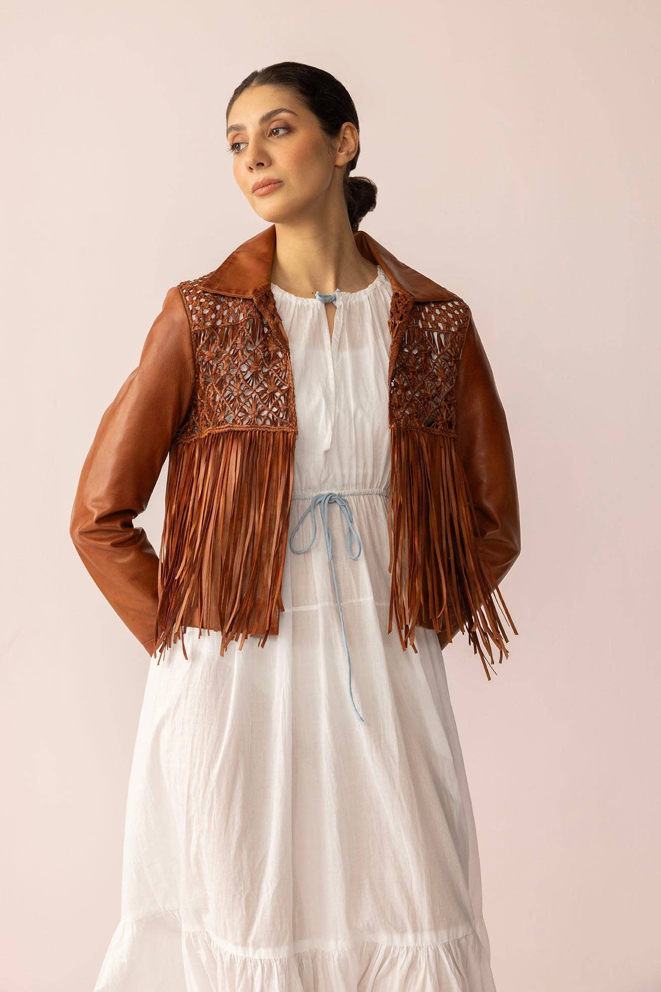 Brown western leather fringe jacket with braided yoke detailing and long fringe accents