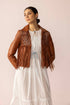Brown western leather fringe jacket with braided yoke detailing and long fringe accents