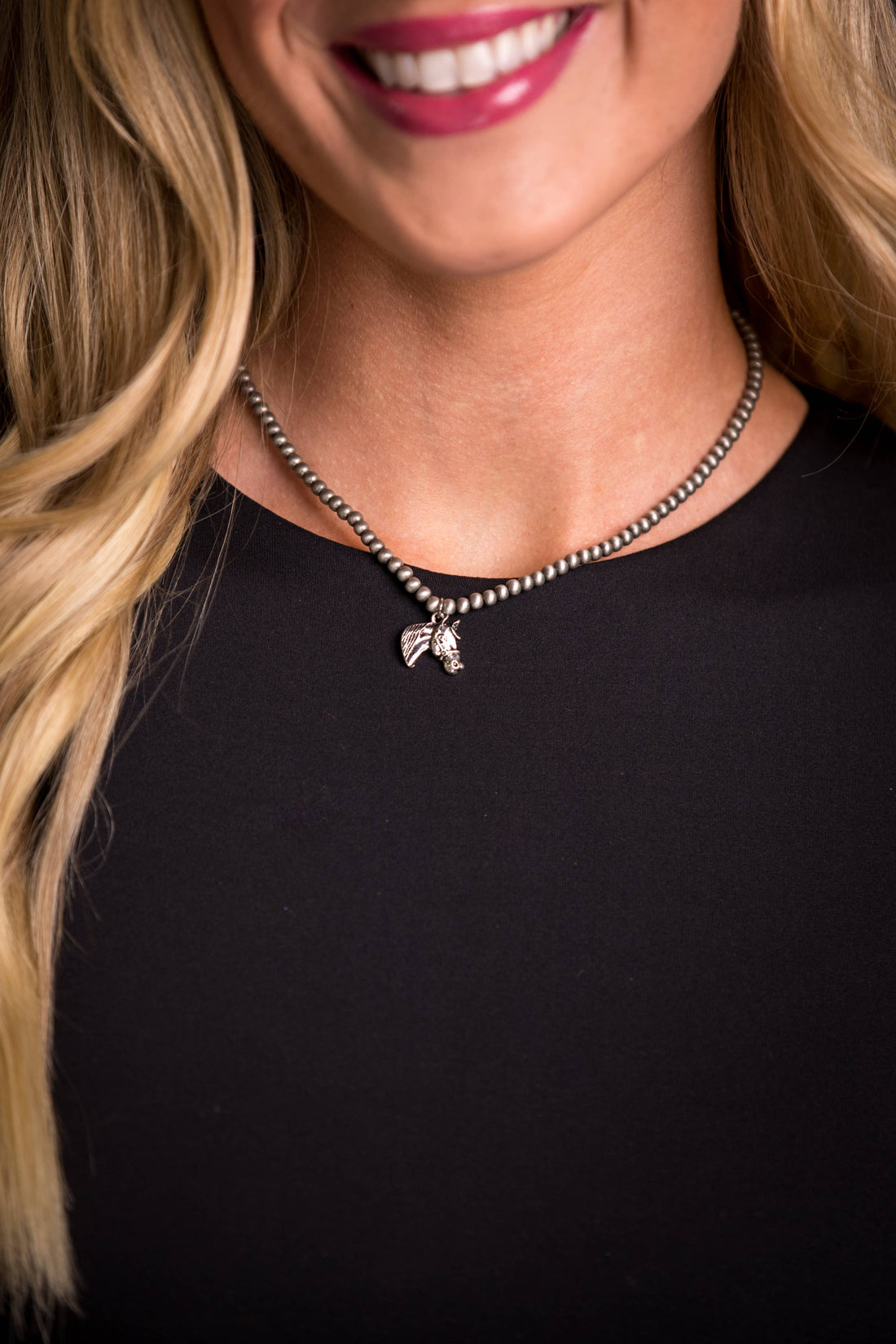 Silver Stallion Navajo Pearl Necklace featuring dainty faux Navajo pearls and a silver horse head charm, showcasing elegant Western style.